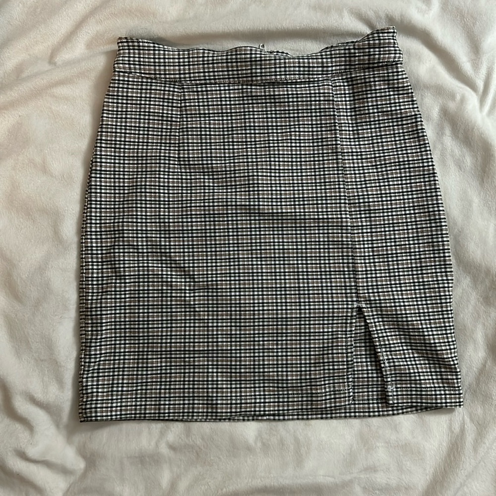 A cute plaid patterned mini skirt with a slit on the front.